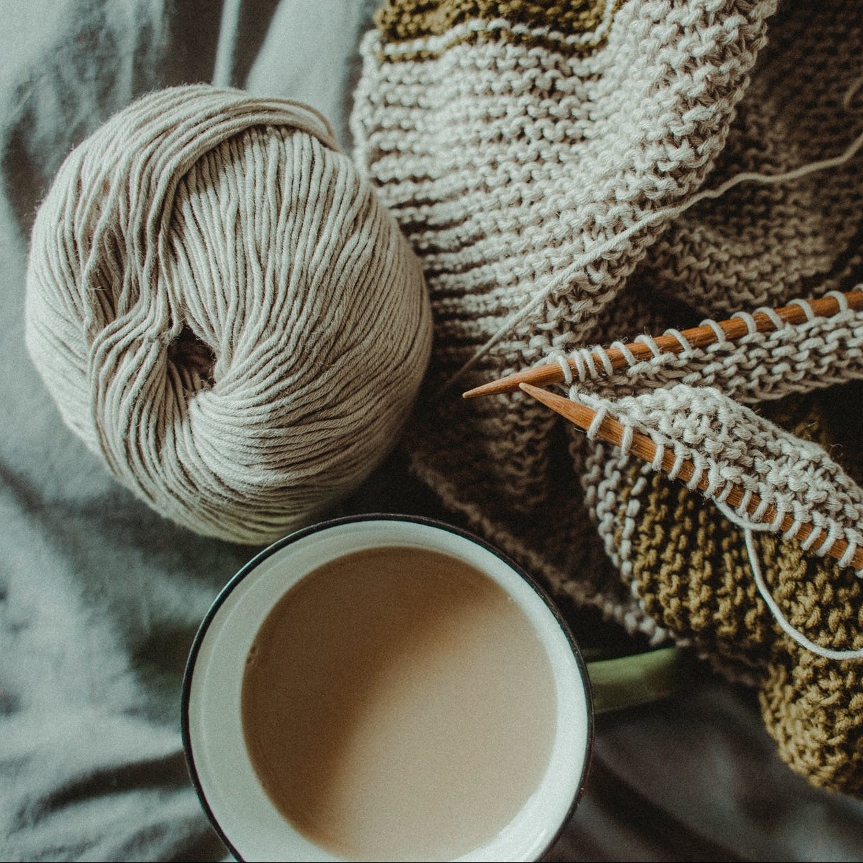 This is an image of knitting with a cup of tea to illustrate our craft workshops and cosy makerspace.